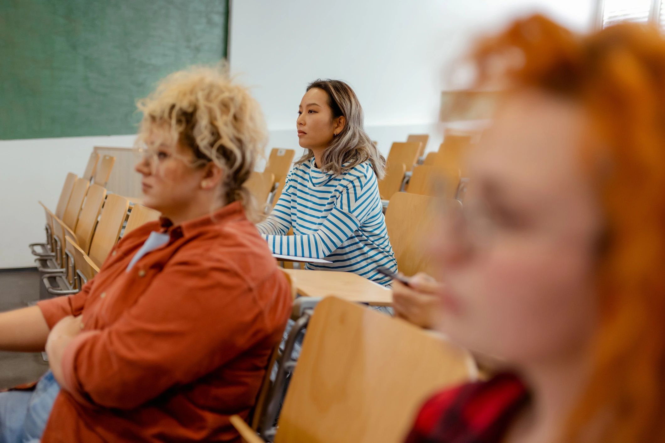 Focused college student in an academic auditorium