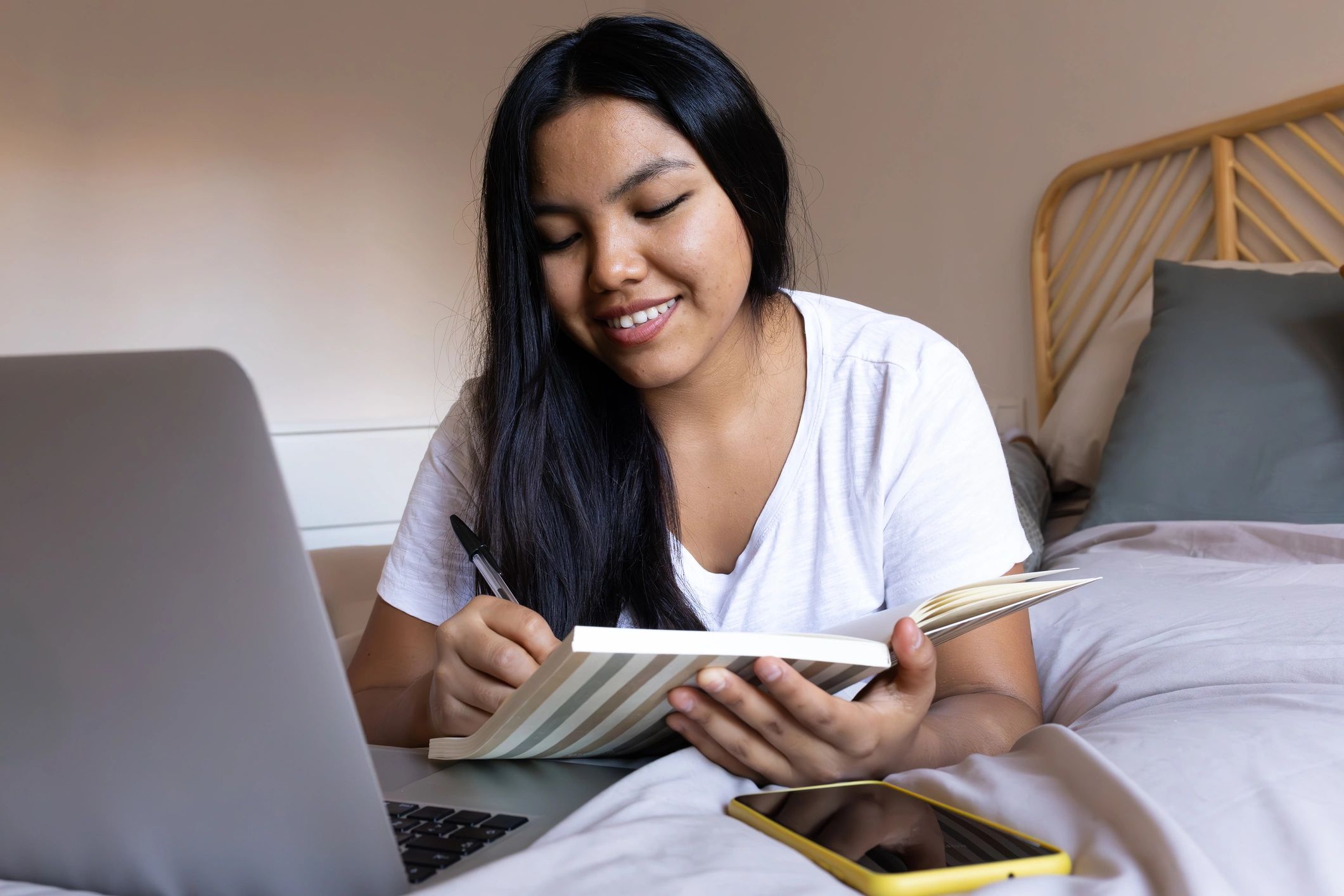 Student taking notes while preparing an application